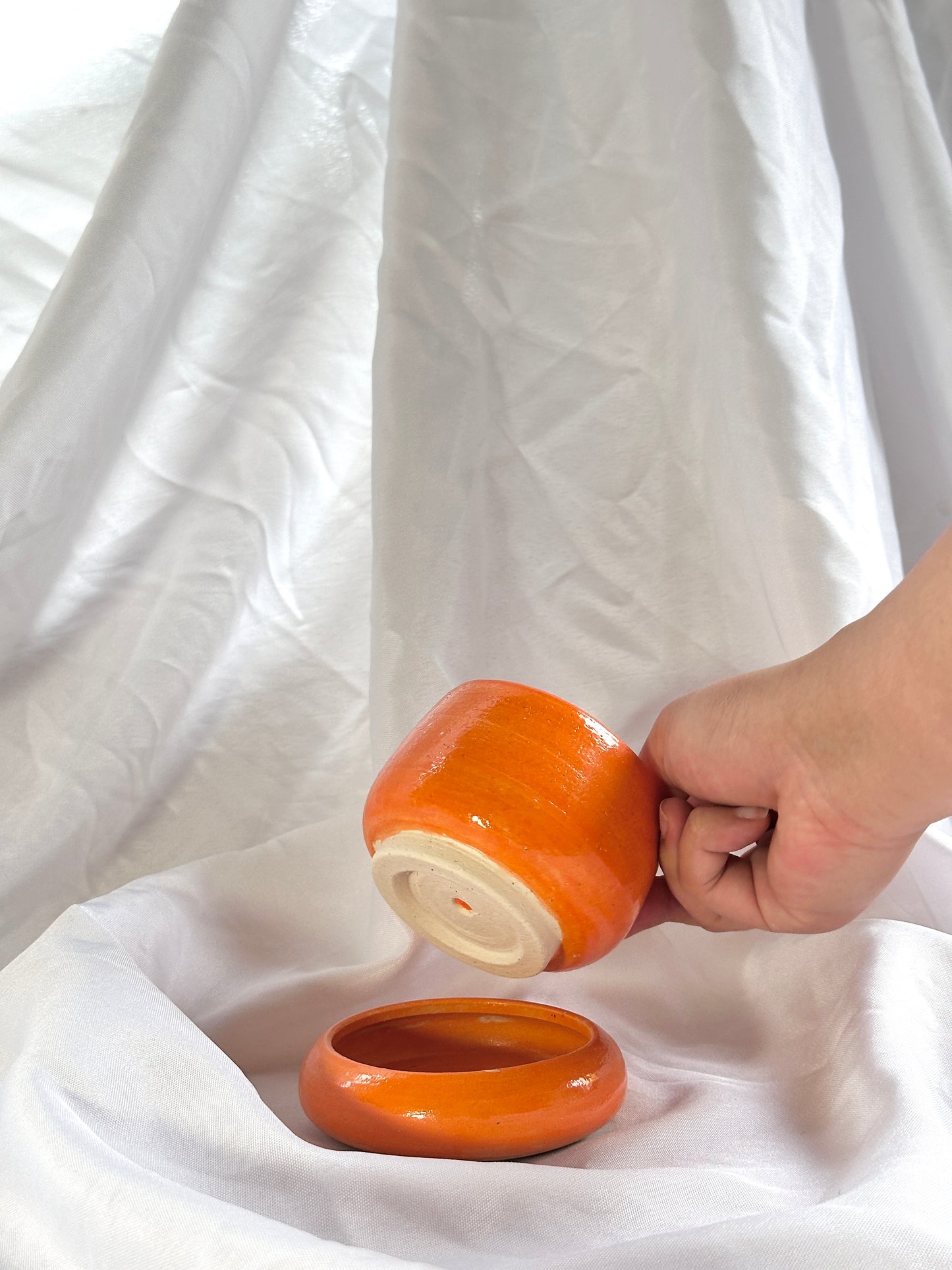 small tiered orange plant pot